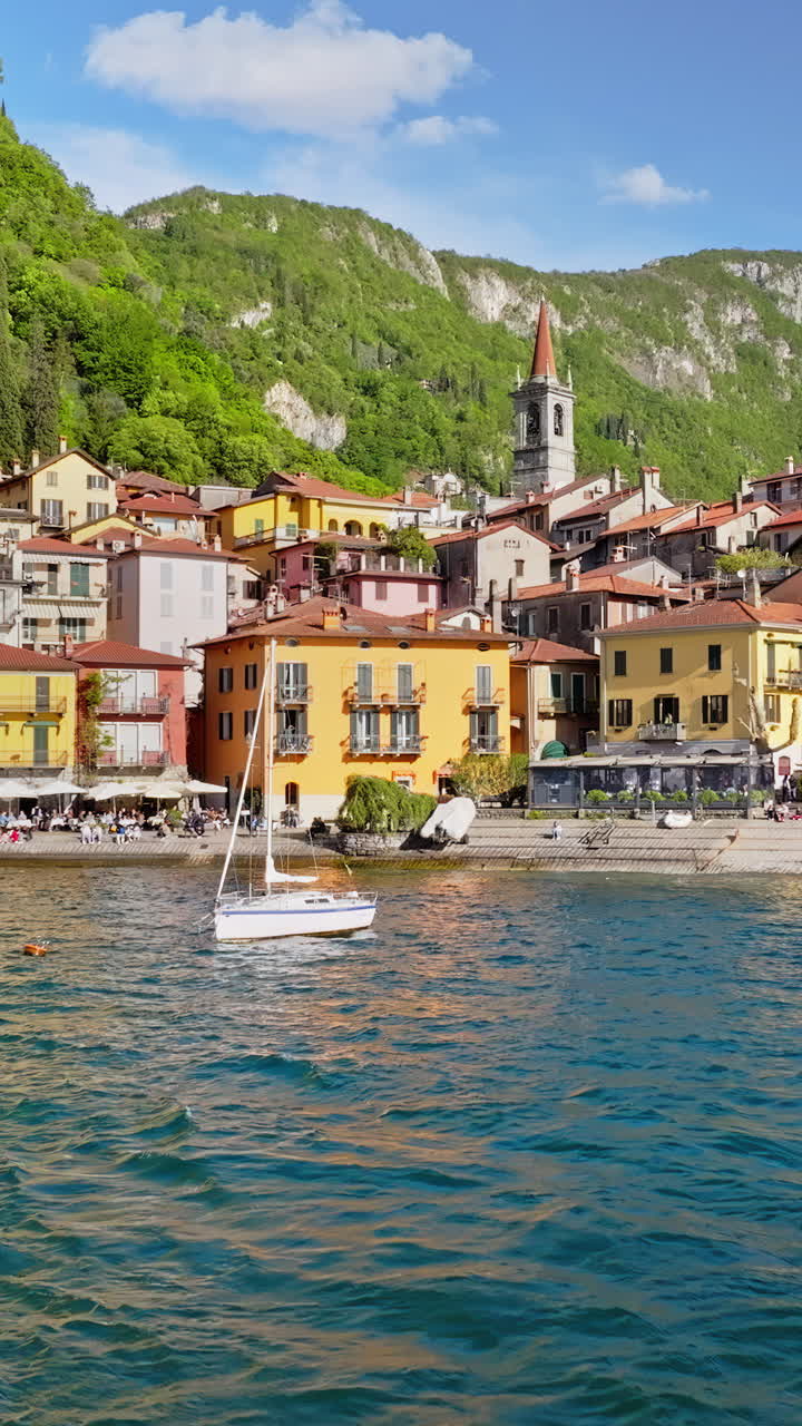 Aerial drone view of boats on the shore of Varenna, Italy near Lake Como. Vertical
