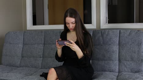 nervous and desperate young attractive woman sitting down and reacting negatively to the mobile phone game message