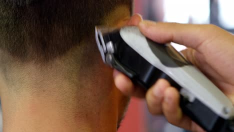 man getting his hair trimmed with trimmer 4k