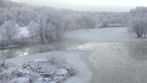 aerial view of a winter scene in upstate new york. shot along a river in the morning.