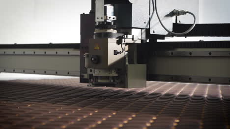 machine cutting foam in a car factory assembly line