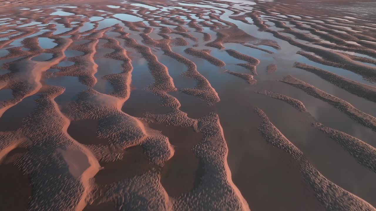 Clouds Reflected In Seawater Pools In Rippled Tidal Sands At Sunset. Fleetwood, Lancashire, UK