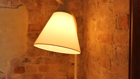 white lamp on a brick wall