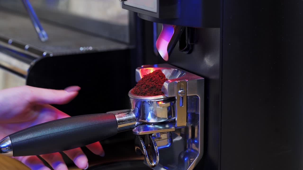 Coffee machine. Grinding coffee beans pouring. Process of making coffee in a modern coffee machine. Close-up.