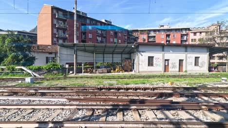 train passing by residential buildings in milan