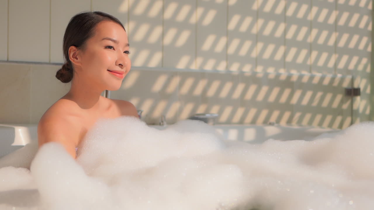 Beautiful Asian Brunette Woman In The Foam Bath