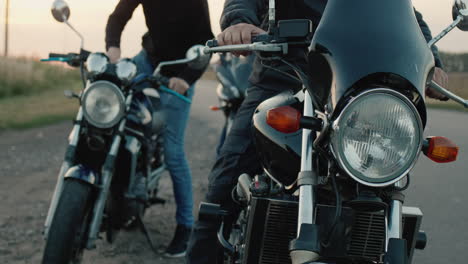 a group of bikers climb on their motorcycles and drive off