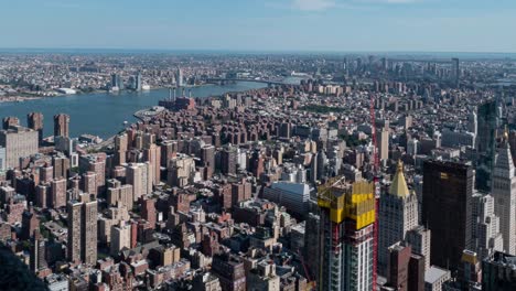 TIME-LAPSE:-Daytime-New-York-City-time-lapse-on-top-of-the-Empire-State-Building-with-Manhattan,-Williamsburg-Bridge,-and-East-River-in-background