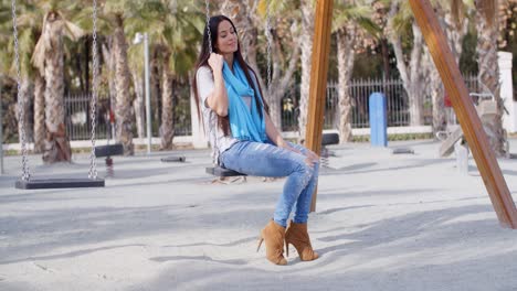 Stylish-young-woman-on-a-swing