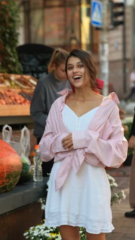 young woman smiling in a city market