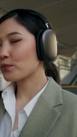 woman drinking coffee and wearing headphones