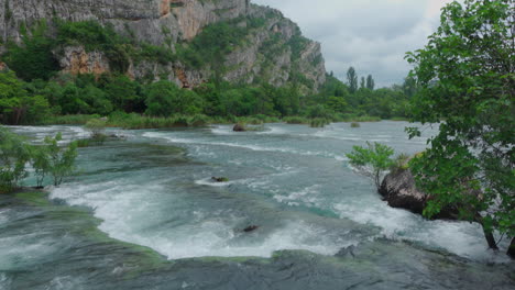 waterfalls in krka with stones looking out of the water