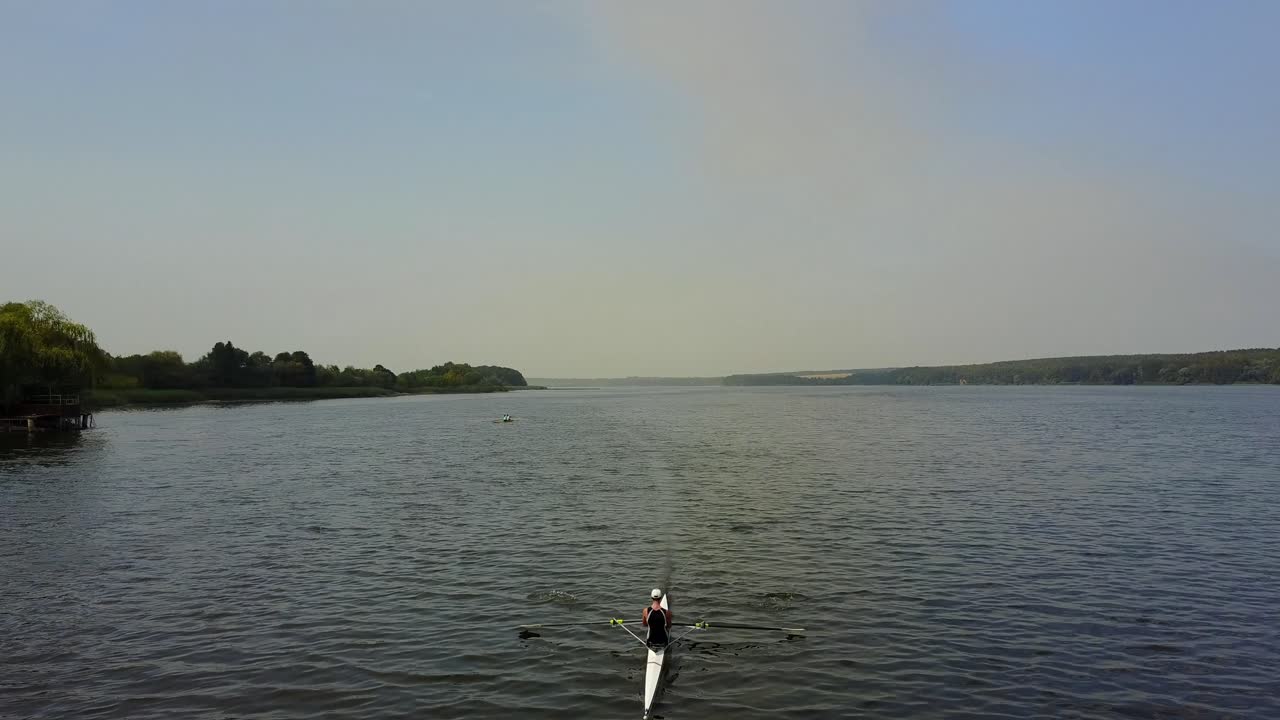 Training Athlete In Kayak. Training of small sportsmen rowers on a kayak on the river
