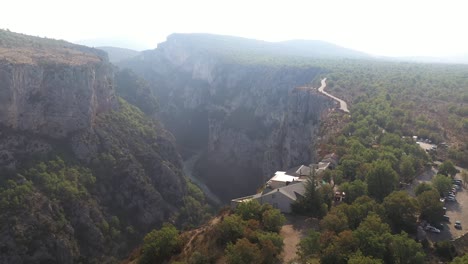 Beautiful-oscillating-aerial-shot-of-the-Verdon-Gorge-hotel-overlooking-the-powerful-canyon-in-France