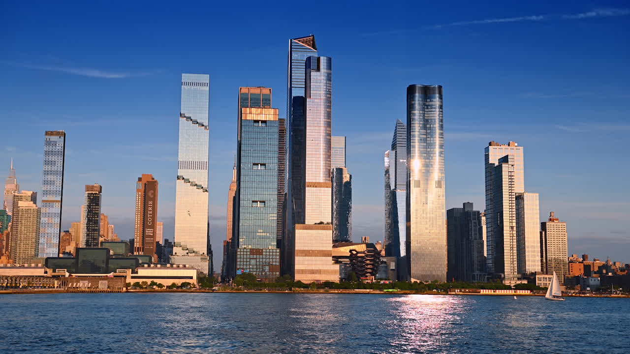 New York, USA, 4 August 2025: Modern Manhattan skyscrapers reflecting sunlight. Tall glass skyscrapers of Manhattan shine under evening sunlight