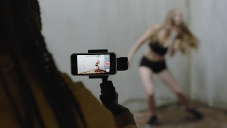 dancing woman young caucasian freestyle dancer performing for friend using smartphone taking video enjoying sharing hip hop dance on social media