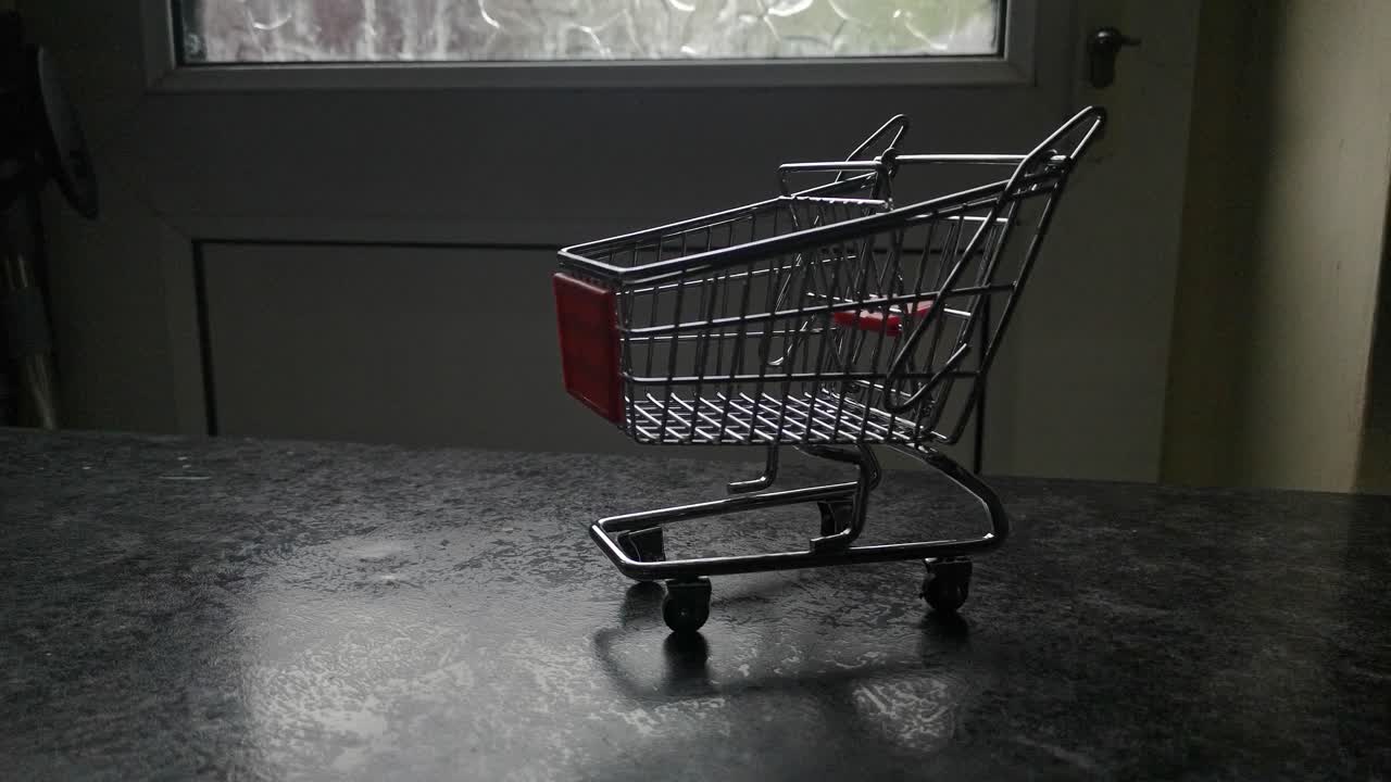 Mini empty shopping cart online home supermarket concept copy space closeup slow right dolly