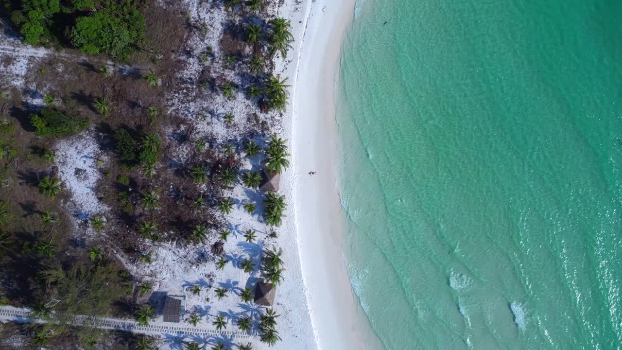 Tourist lying on a beautiful tropical beach, enjoying the sun and the sound of the waves. Nice aerial view flight speed ramp hyper motion time lapse