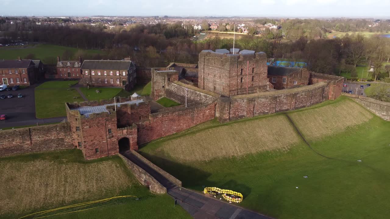Aerial cinematic of front gate and facade of 11th Century Carlisle Castle - Cumbria, England
