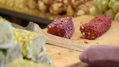 cutting traditional turkish delight with pistachios and rose petals