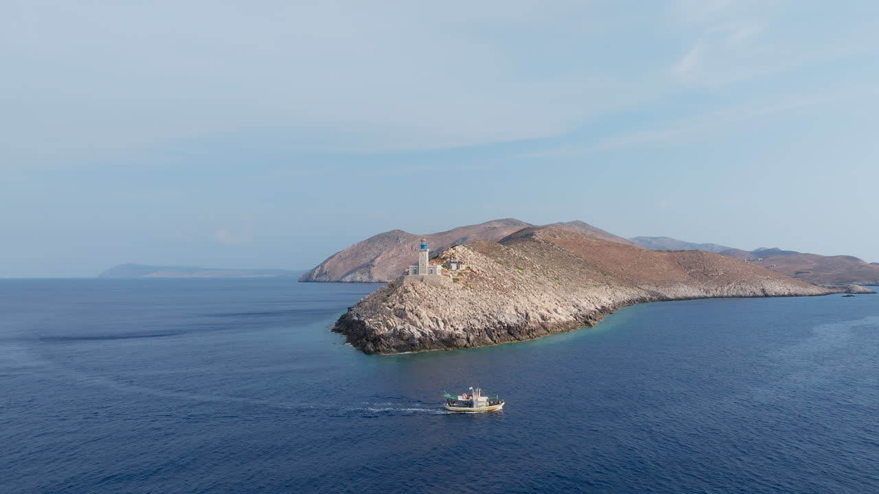 Panoramic aerial of Cape Tainaron headland as rocky coast meets open sea and blue sky horizon