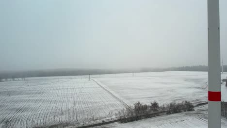 white snowy farm field - aerial view