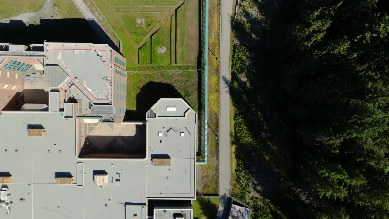 Fraser Regional Correctional Centre, Maple Ridge, British Columbia, Canada - Et tagudsigt over et fængsel omgivet af tæt skov - Luftfoto ovenfra