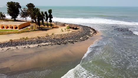 aerial view of ocean bay hotel beach with beach hut and waves crashing on the shore