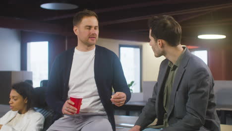 two men talking together at the office party