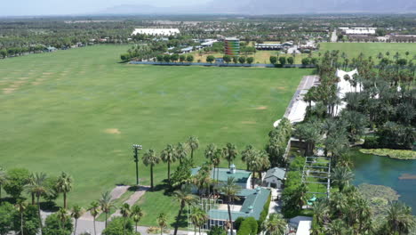 empty, desolate and closed empire polo club in green rural countryside at coachella valley music and arts festival, covid-19 quarantine, above rising aerial