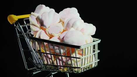 Sweets-In-A-Shopping-Trolley-On-A-Black-Background-4k-Video