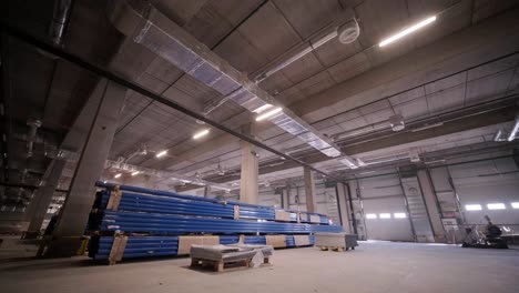 big and modern warehouse under construction, featuring metal shelving and other industrial equipment.