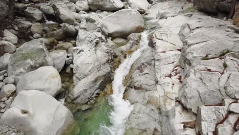 peaceful river stream in restonica valley, small waterfall, drone flying down
