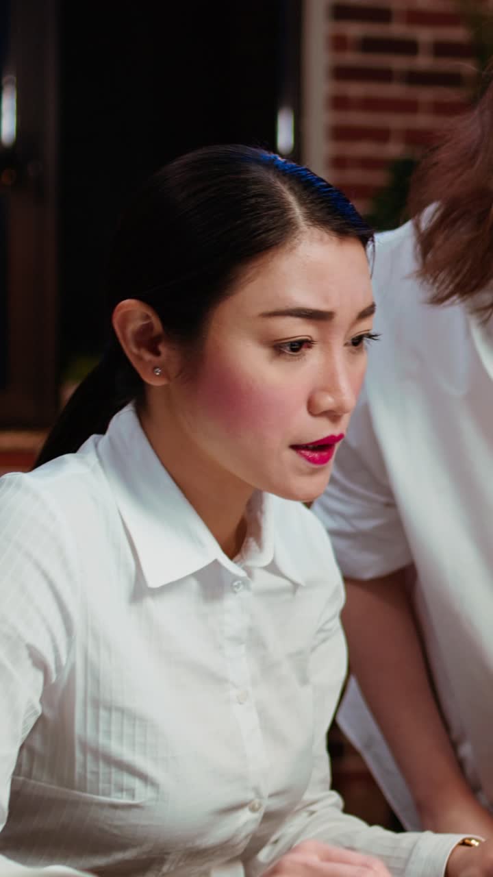 Vertical video Businesswoman and colleague working together doing tasks for team project