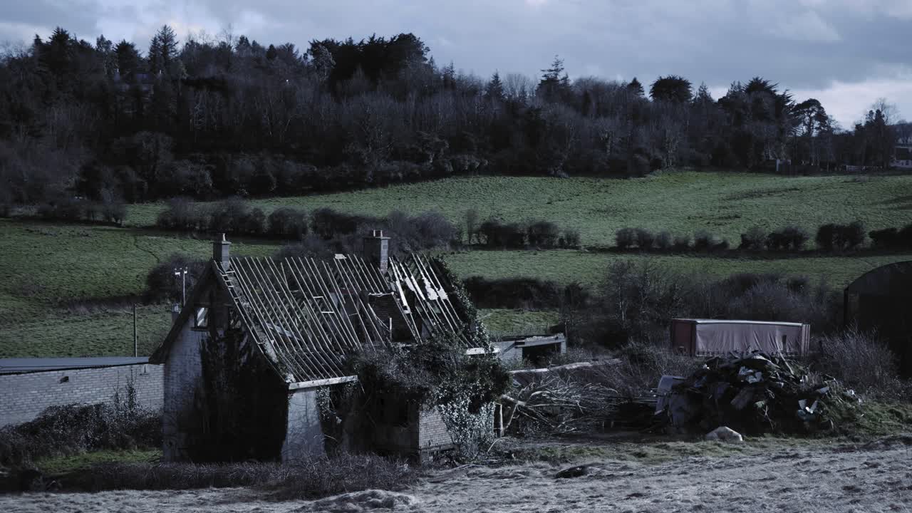 A Damaged Shelter In The Middle Of The Greenfield And Forest In Northern Ireland. -wide shot