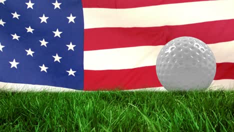 Animation-of-golf-ball-on-grass-over-waving-flag-of-usa