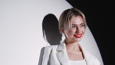 woman in white blazer smiling