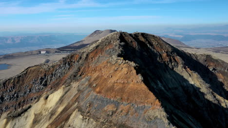 wide drone shot of mountain range near the volcano mount aso