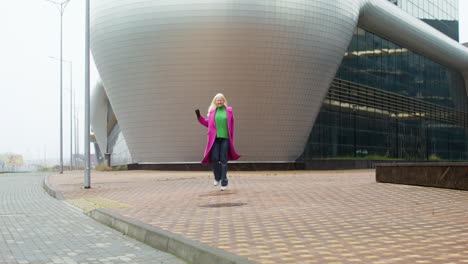 happy woman holding coffee cup outdoors