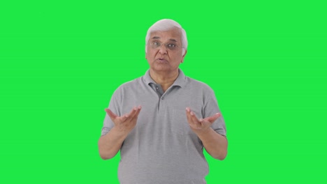 Indian-old-man-talking-to-someone-Green-screen