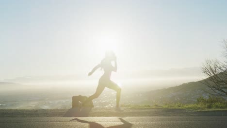african american woman exercising outdoors running in country side during sunset