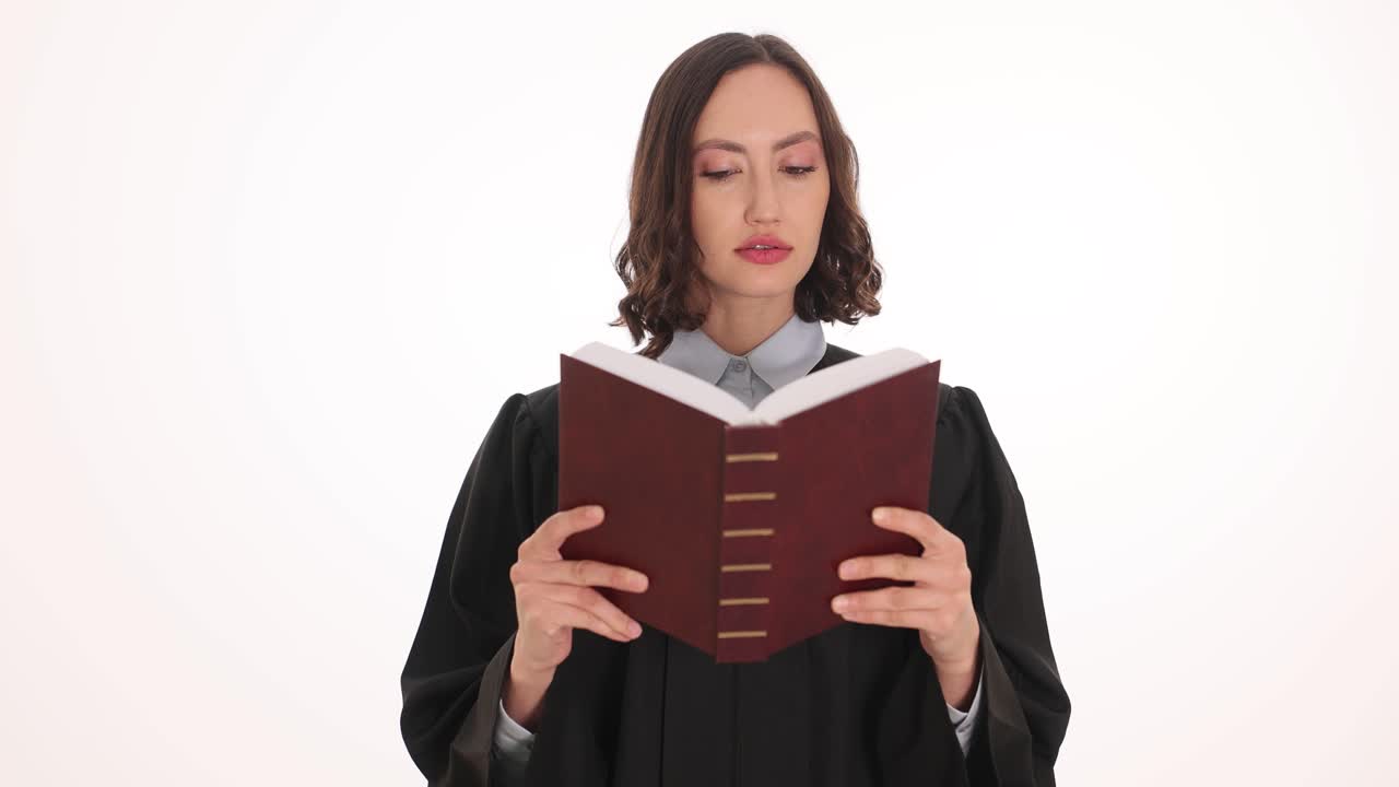 Woman in judge gown reading a book