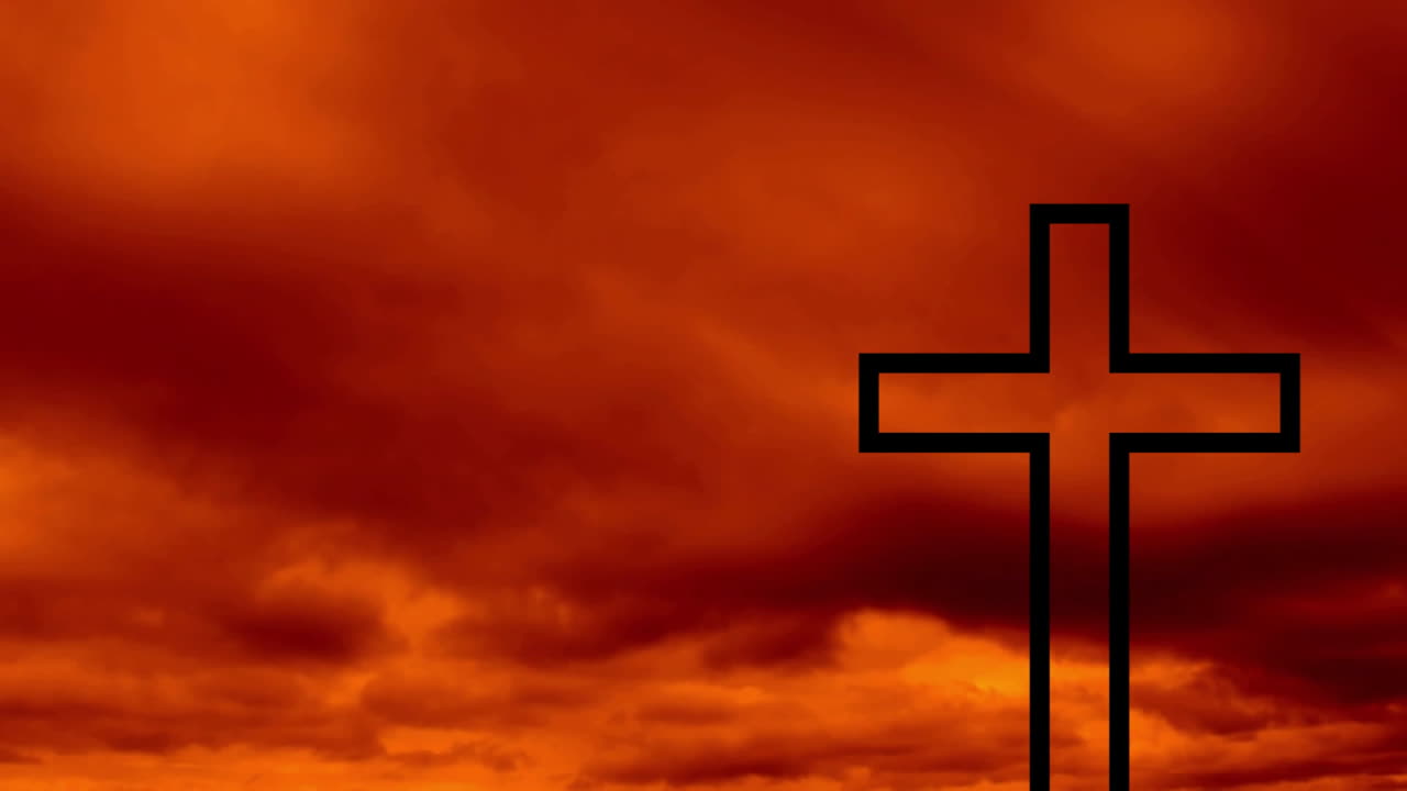 Cross silhouette against dramatic orange and red cloudy sky at sunset