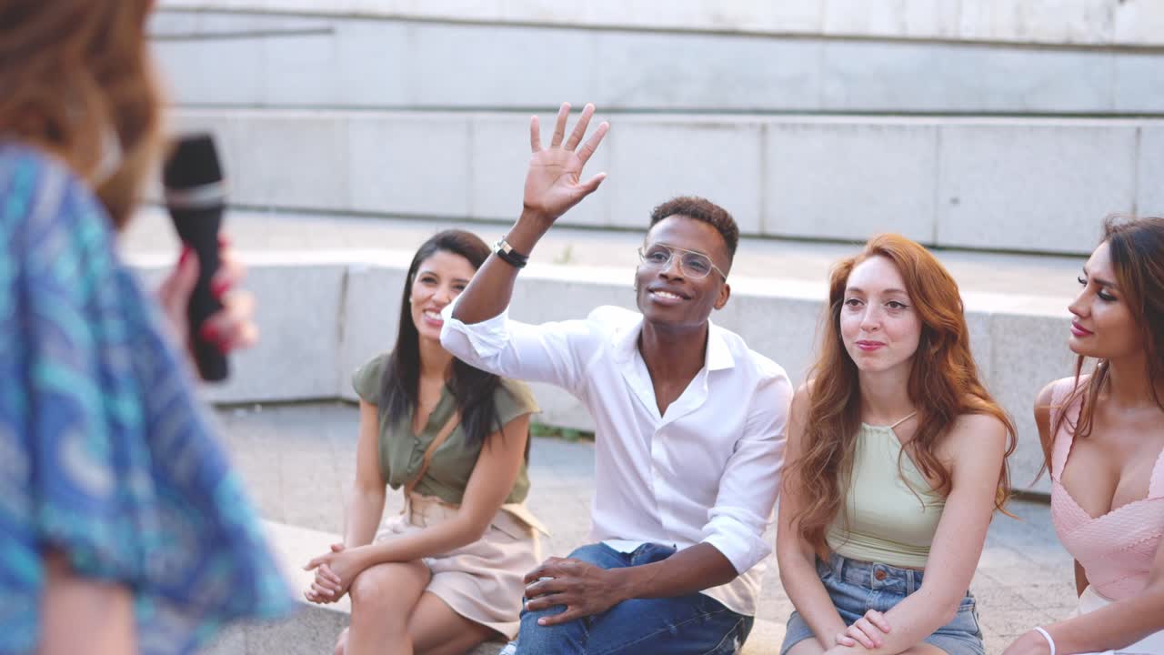 Diverse group of people attending an outdoor discussion or Q&A session