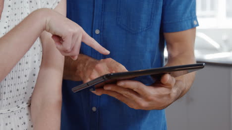 Cute-couple-using-tablet-while-listening-to-music