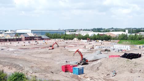 UK-town-housing-development-working-foundation-construction-site-aerial-view