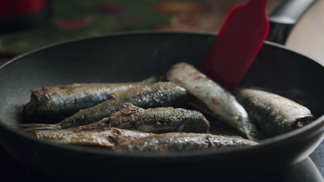 Appetizing fried sardines on the hot pan
