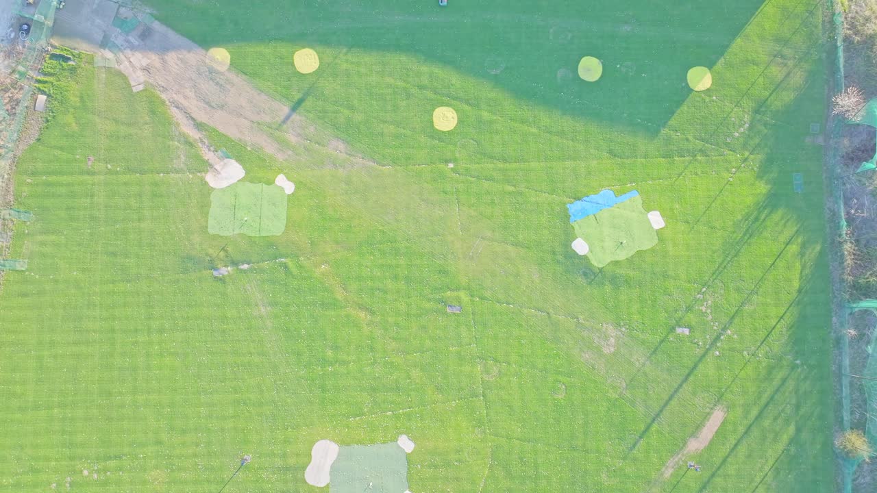 Top-down rising aerial drone shot of the driving range at Waterfront Golf Club, Rotherham, South Yorkshire, UK,