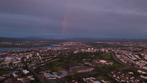 beautiful rainbow during sunset in reykjavik iceland aerial shot