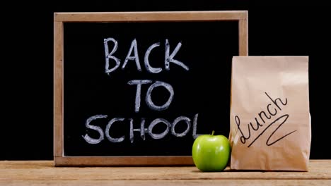 Slate,-apple-and-paper-bag-on-table